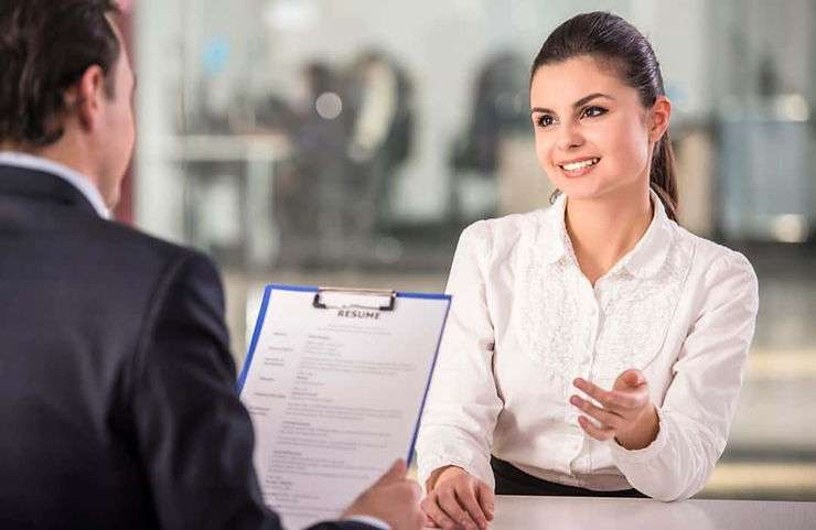 Woman talking about resume content at interview mosh jd® Woman in interview going over resume.