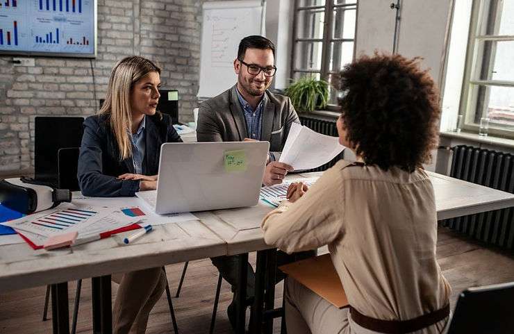 Coworkers discussing the importance of comprehensive job descriptions