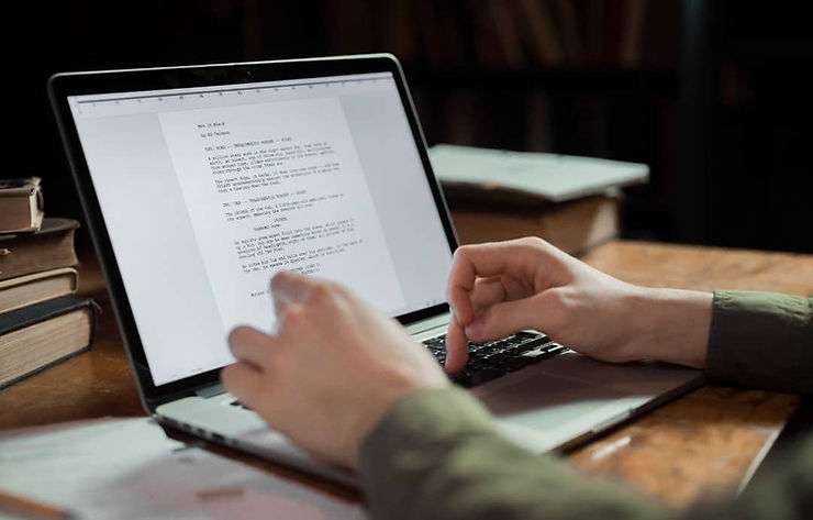 Person typing on laptop.